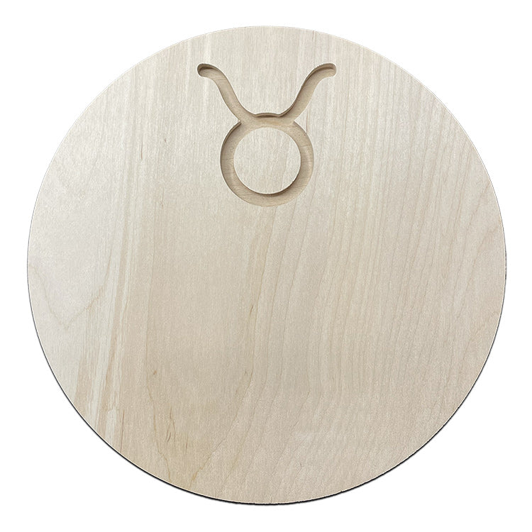 a circular wood canvas with a taurus symbol carved into it