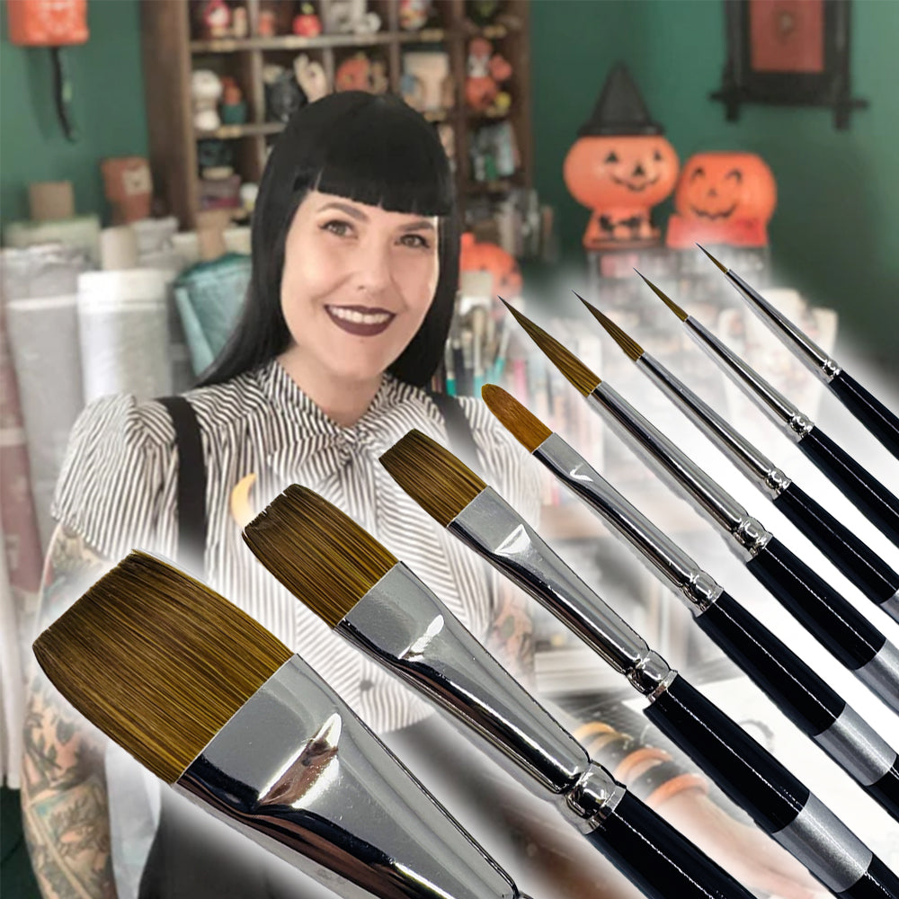 a woman standing behind a row of paint paint brushes