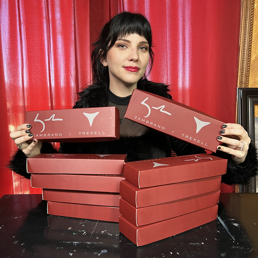 a person holding two red boxes with more boxes under them